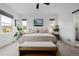 Bright main bedroom showcases two windows, neutral tones, and modern decor at 4465 Mesa Top Dr, Monument, CO 80132