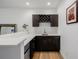 Wet bar includes wine racks, mini fridge, white counter top, and hardwood floors at 4465 Mesa Top Dr, Monument, CO 80132