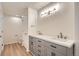Bathroom featuring double sinks, modern fixtures, and wood look flooring at 8500 E Jefferson # 3C, Denver, CO 80237