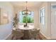 Cozy dining room with modern chandelier, a round table, and a large window providing natural light at 8500 E Jefferson # 3C, Denver, CO 80237