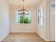 Bright dining room with big windows, modern chandelier and wood flooring at 8500 E Jefferson # 3C, Denver, CO 80237