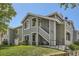 Well-maintained two-story condo with lush lawn, featuring a staircase entrance and gray exterior at 8500 E Jefferson # 3C, Denver, CO 80237