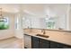 Well-lit kitchen boasting modern appliances, granite countertops, and a view into the living room at 8500 E Jefferson # 3C, Denver, CO 80237