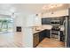 Modern kitchen open to the living room featuring stainless appliances, granite countertops and wood flooring at 8500 E Jefferson # 3C, Denver, CO 80237
