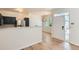 Open-concept living room featuring modern light fixtures, hard wood flooring, and stainless steel appliances at 8500 E Jefferson # 3C, Denver, CO 80237