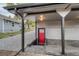 Exterior of home with a red door and covered concrete patio at 2795 W Ellsworth Ave, Denver, CO 80219