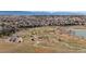 Aerial view capturing nearby trails and natural park area, located within a neighborhood and surrounding a lake at 13673 Osage St, Broomfield, CO 80023