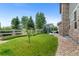 Lush backyard with manicured lawn, privacy fence, mature trees, and a cozy seating area at 13673 Osage St, Broomfield, CO 80023