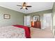 A Primary bedroom features a carpeted floor, a wood dresser, and a comfortable-looking bed with floral sheets at 13673 Osage St, Broomfield, CO 80023