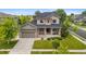 Charming two-story home with a well-manicured lawn, a two-car garage, and stone and siding exterior at 13673 Osage St, Broomfield, CO 80023