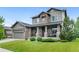 Charming home with a covered front porch, stone accents, manicured lawn, and an attached garage at 13673 Osage St, Broomfield, CO 80023