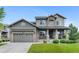 Charming two-story home with a well-maintained front yard and inviting stone-accented entrance at 13673 Osage St, Broomfield, CO 80023