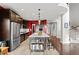 Modern kitchen with stainless steel appliances, a large island, and dark cabinetry at 13673 Osage St, Broomfield, CO 80023
