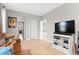 Comfortable living room boasts plush carpeting, neutral walls, and is equipped with entertainment center and large screen TV at 13673 Osage St, Broomfield, CO 80023