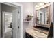 Well-lit bathroom showcasing a vanity with a sink and open shelving with accessories at 13673 Osage St, Broomfield, CO 80023
