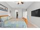 Inviting bedroom featuring a comfortable bed, a TV, and a walk-in closet at 13673 Osage St, Broomfield, CO 80023