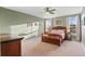 Cozy bedroom featuring carpet, two windows, neutral walls, and a ceiling fan at 13673 Osage St, Broomfield, CO 80023