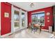 Dining room with red walls, a table and chairs, and sliding doors to the outside at 13673 Osage St, Broomfield, CO 80023