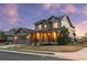 Beautiful two-story home featuring stone accents, a covered porch, and manicured landscaping at 13673 Osage St, Broomfield, CO 80023