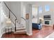 Elegant staircase and living room in a home with high ceilings and natural light at 13673 Osage St, Broomfield, CO 80023