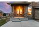 Inviting front porch with stone pillars and a double-door entry, creating a warm welcome at 13673 Osage St, Broomfield, CO 80023