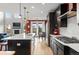 Spacious kitchen with large island, stainless appliances, and tile flooring adjacent to dining area at 13673 Osage St, Broomfield, CO 80023