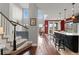 Open-concept living space featuring high ceilings, hardwood floors, and a seamless flow to the kitchen at 13673 Osage St, Broomfield, CO 80023