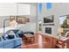 Sunlit living room featuring hardwood floors, a fireplace, and large windows at 13673 Osage St, Broomfield, CO 80023