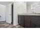 Double vanity bathroom with dark brown cabinets at 26774 E Archer Ave, Aurora, CO 80018