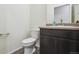 Powder room with dark brown vanity at 26774 E Archer Ave, Aurora, CO 80018