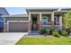 Brick ranch home with front porch and landscaped lawn at 26774 E Archer Ave, Aurora, CO 80018