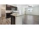Open concept kitchen with island and stainless steel appliances at 26774 E Archer Ave, Aurora, CO 80018