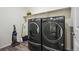 Laundry room with washer, dryer, and extra shelving at 26774 E Archer Ave, Aurora, CO 80018