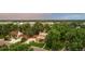 An aerial view showcases a charming home nestled among lush trees, enhancing its privacy and curb appeal at 11796 W 53Rd Pl, Arvada, CO 80002