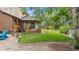 Backyard featuring a well-maintained lawn, landscaping and a covered patio area, perfect for outdoor relaxation at 11796 W 53Rd Pl, Arvada, CO 80002