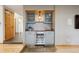A dry bar featuring glass front cabinets and a wine refrigerator at 11796 W 53Rd Pl, Arvada, CO 80002