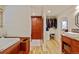 Bathroom offers views to a wardrobe, custom storage and double granite sinks at 11796 W 53Rd Pl, Arvada, CO 80002