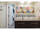 Bathroom featuring a vanity with three vessel sinks, decorative mirrors, and modern fixtures at 11796 W 53Rd Pl, Arvada, CO 80002