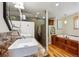 Modern bathroom offers double sinks, a glass shower, and a luxurious soaking tub with wood trim at 11796 W 53Rd Pl, Arvada, CO 80002