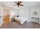 Cozy bedroom with a ceiling fan, neutral walls, and carpet, creating a comfortable and inviting space at 11796 W 53Rd Pl, Arvada, CO 80002