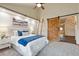 Bedroom features vaulted ceilings, a ceiling fan, a comfortable bed, a decorative wooden ladder, and an entry at 11796 W 53Rd Pl, Arvada, CO 80002