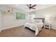 Bright bedroom featuring carpet, decor shelving, and a large window providing natural light at 11796 W 53Rd Pl, Arvada, CO 80002