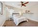 Comfortable bedroom offering carpet, bright natural light, decor shelving, and a cooling ceiling fan at 11796 W 53Rd Pl, Arvada, CO 80002