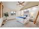 Bright bedroom features vaulted ceilings, a ceiling fan, a comfortable bed, and a decorative wooden ladder at 11796 W 53Rd Pl, Arvada, CO 80002
