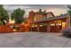 Rear view of a house, featuring a three-car garage, a fenced yard, and a multi-level deck at 11796 W 53Rd Pl, Arvada, CO 80002