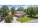 Stunning two-story home with a three-car garage, mature trees, and lush green lawn at 11796 W 53Rd Pl, Arvada, CO 80002
