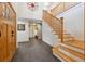 Grand foyer with high ceilings, a wooden staircase, tile floors, and a wooden front door at 11796 W 53Rd Pl, Arvada, CO 80002