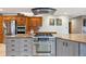 Modern kitchen with stainless steel oven, sleek range hood, granite countertops, and custom wood cabinets at 11796 W 53Rd Pl, Arvada, CO 80002
