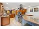 Spacious kitchen featuring stainless steel appliances, custom wood cabinetry, and an expansive island with granite countertops at 11796 W 53Rd Pl, Arvada, CO 80002