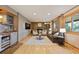 Cozy living room featuring a stone fireplace, built-in shelving, and hardwood floors at 11796 W 53Rd Pl, Arvada, CO 80002